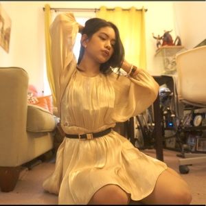 Gold/cream colored dress.